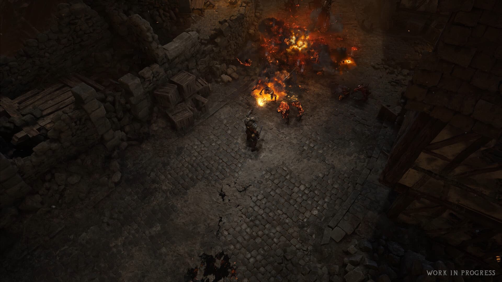 Wolcen 2 combat on a cobbled street among stone ruins and flames, with the original work-in-progress marking.